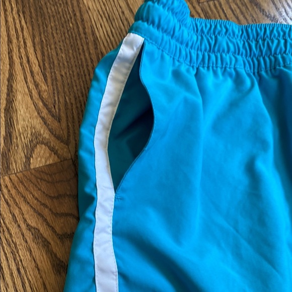 Bright turquoise with white side stripe Nike shorts with pockets, size women’s L - Picture 12 of 16